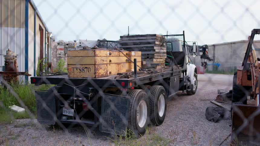 A truck in the lot has supplies loaded up