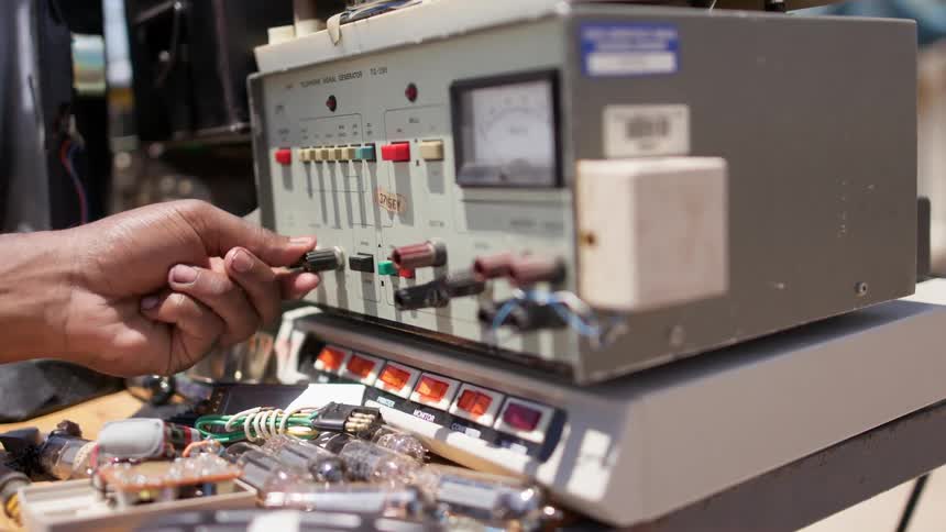 A man pushes buttons on equipment