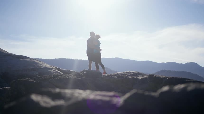 A couple hug on the mountain