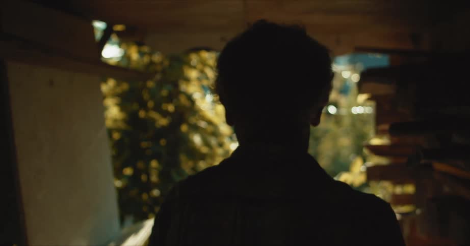 Person walks down hallway towards outdoors