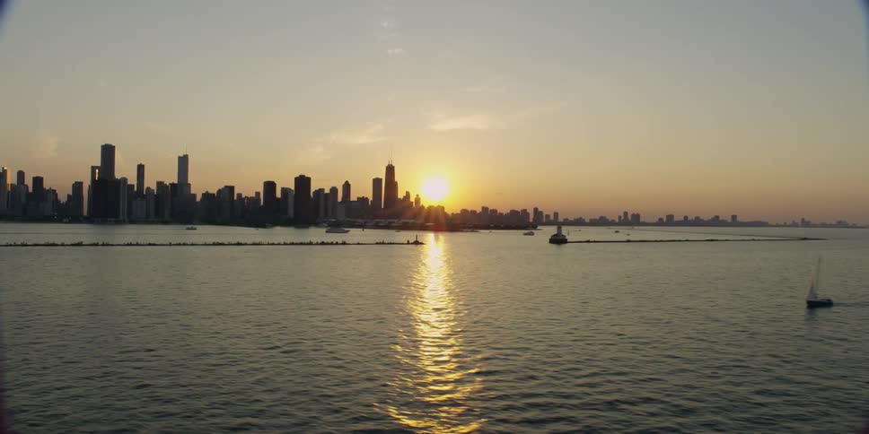 The sun sets over a cityscape