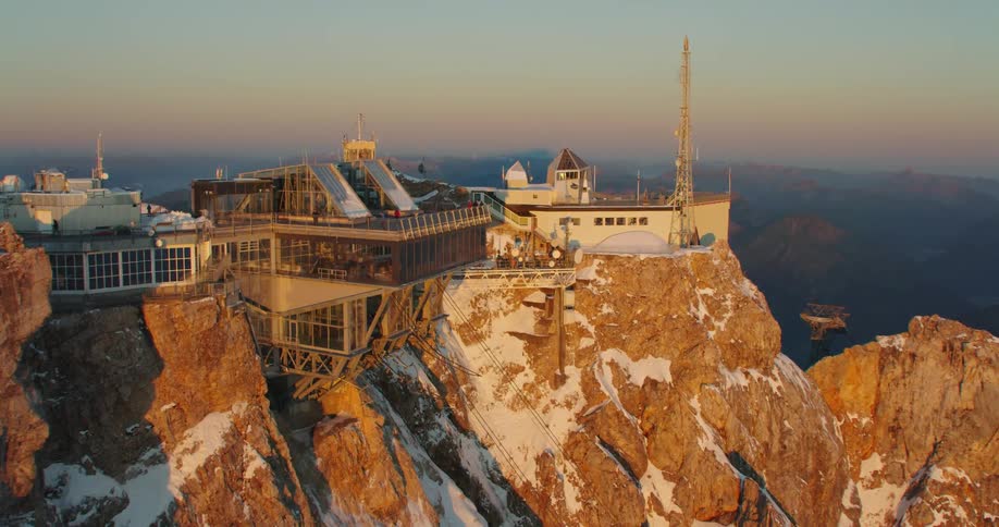 People standing on a deck at an observatory on a mountain top