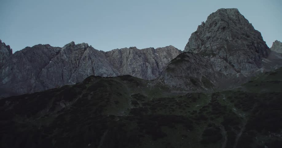 The tall mountains reach into the clear sky