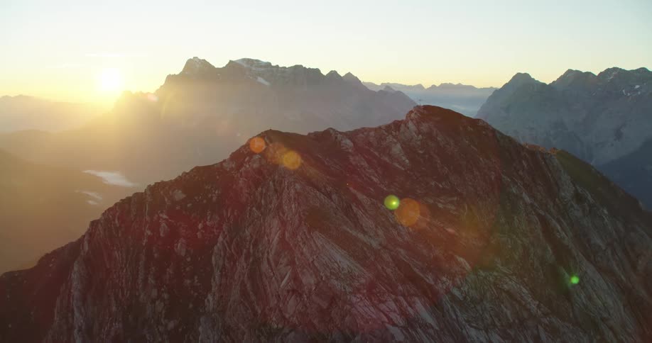 An aerial view of a mountainous region at dawn