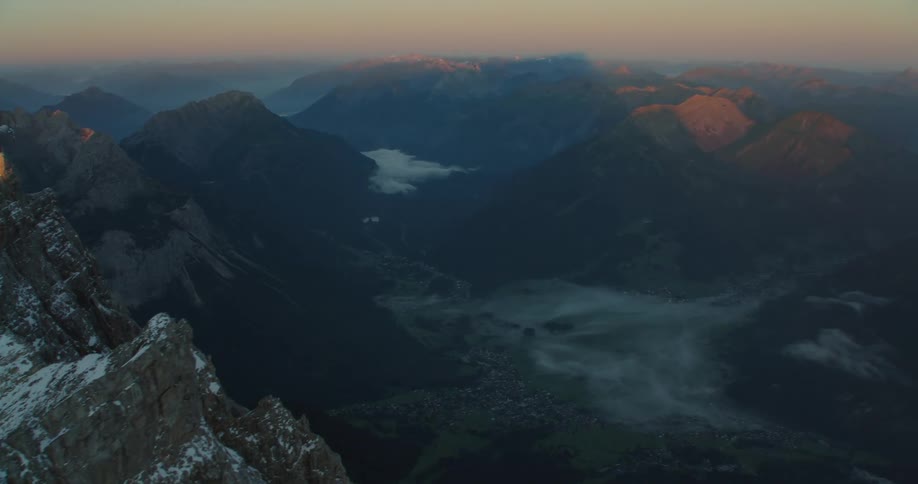 The mountains rise high above the clouds