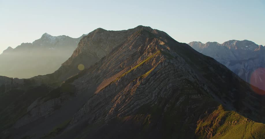 Mountain range with peaks close to the sky and clouds