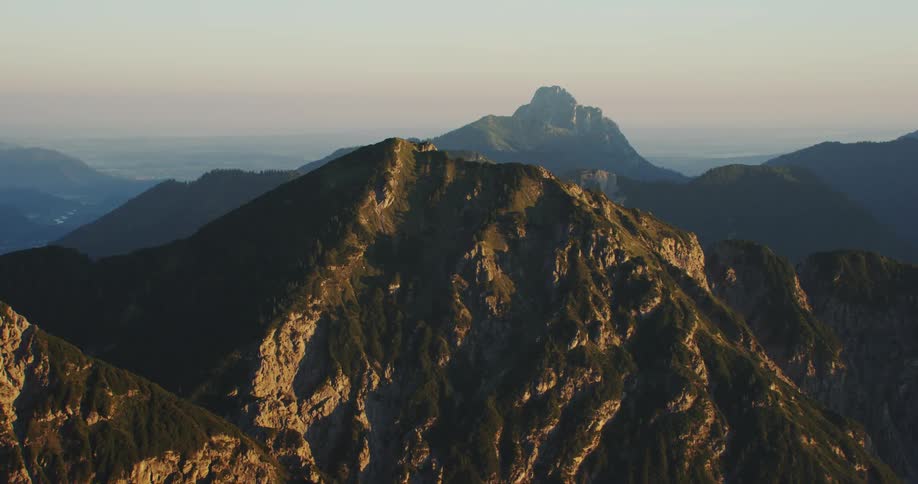 A mountain range with many peaks near the hazy sky