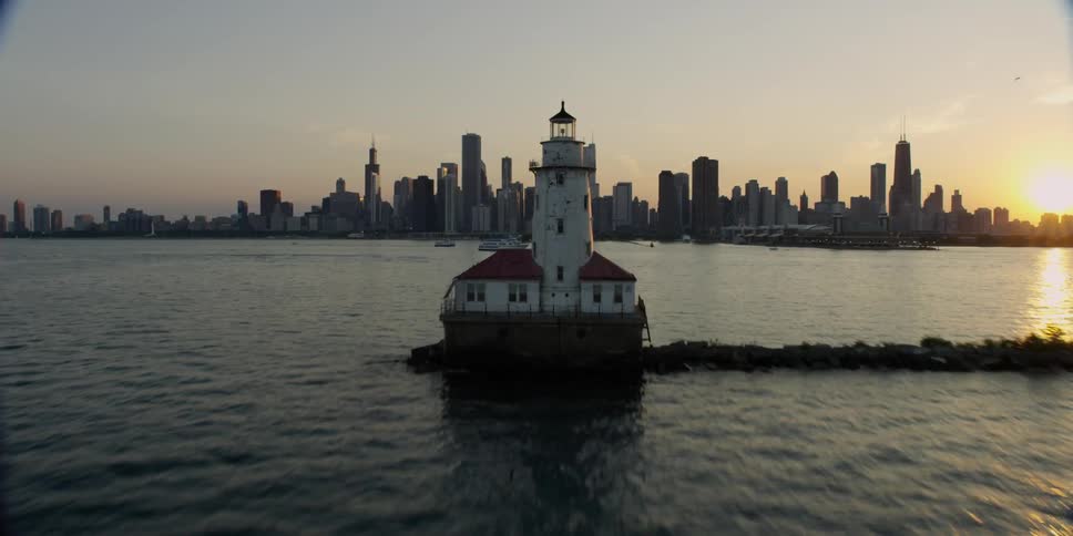 A city on a body of water near sunset