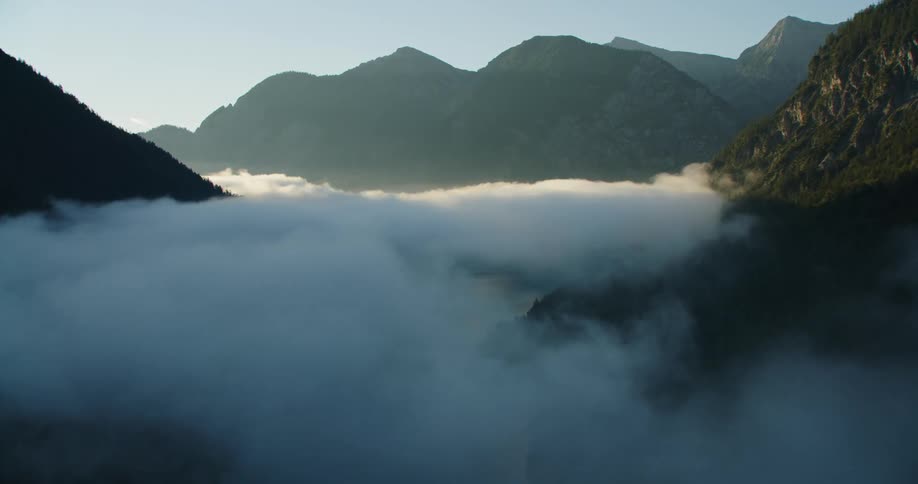 The clouds float near the mountain top