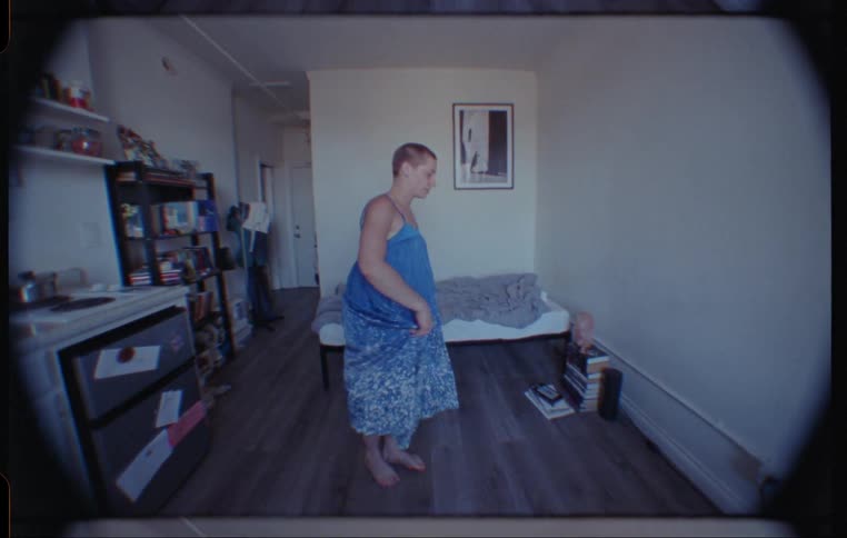 Person in dress dances and spins in bedroom