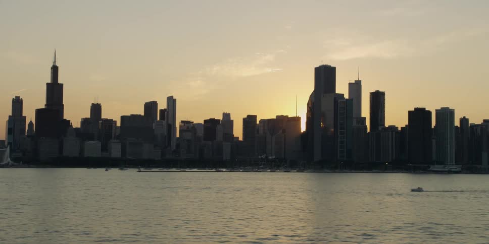 The sun is setting behind a city