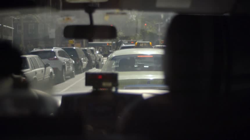 A taxi sitting in a traffic jam