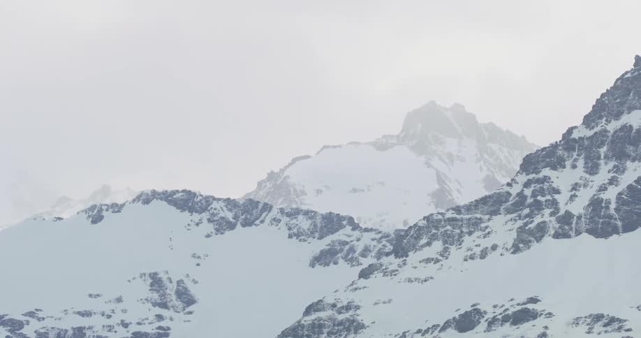 View of foggy snow capped mountains