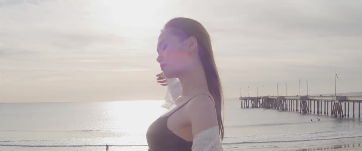 A woman is dancing on the beach