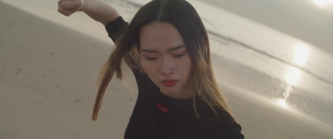 An asian woman is outdoors at the beach