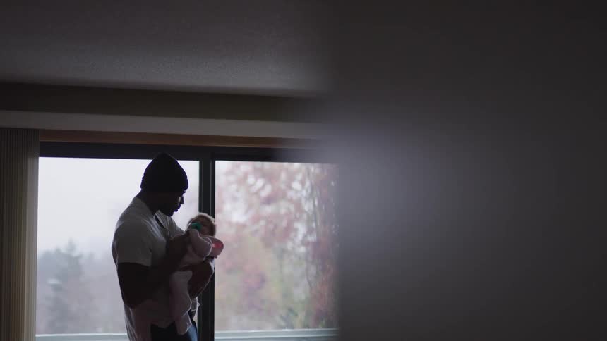 A father is rocking his baby