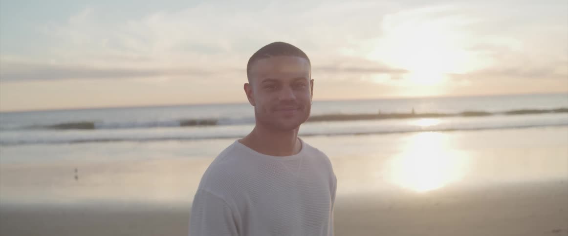 A man is walking on the beach