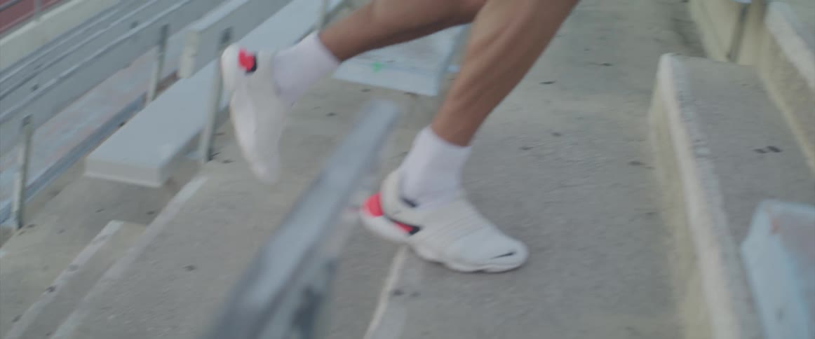 A man running up stadium stairs for exercise