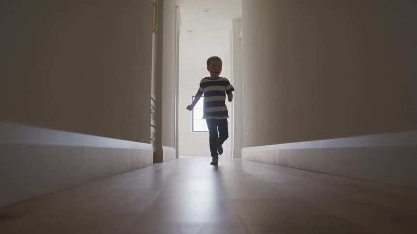 A child runs down the hallway