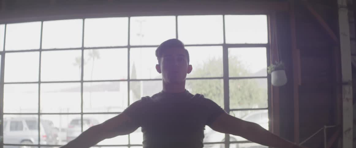 A man is stretching inside a building