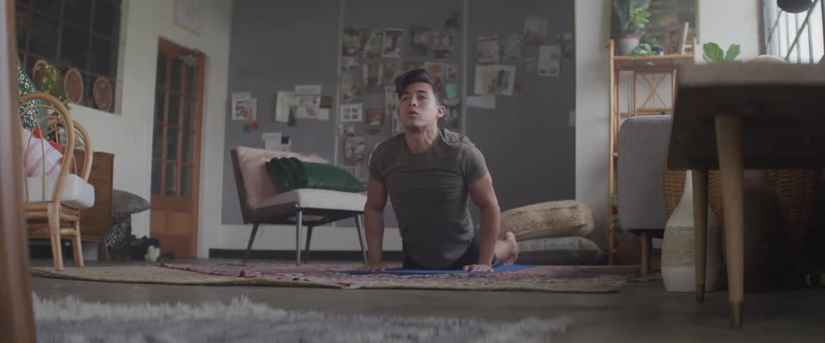 A man pushes his upper body upward from the floor in a yoga pose