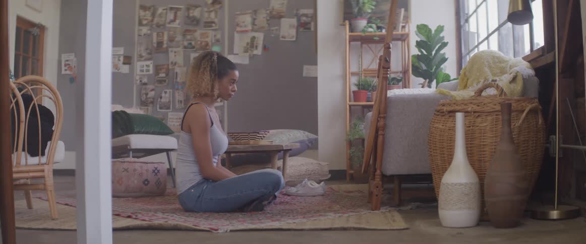 Woman sitting on floor with legs crossed