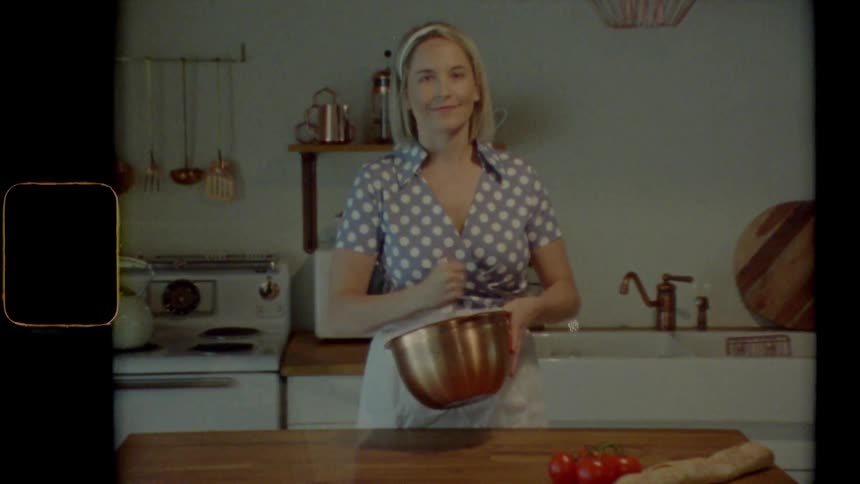 A female mixing a batter in a mixing bowl