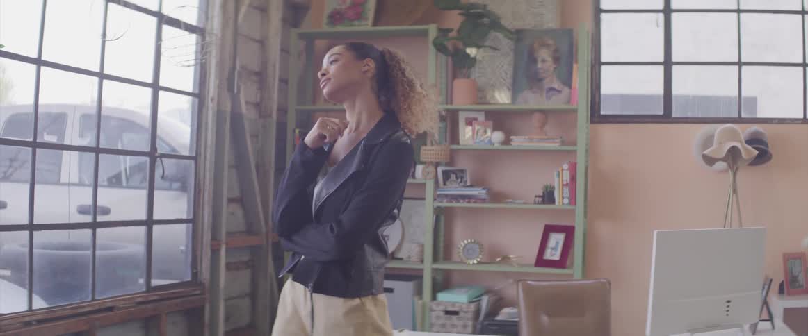 Woman paces back and forth stopping to look out window