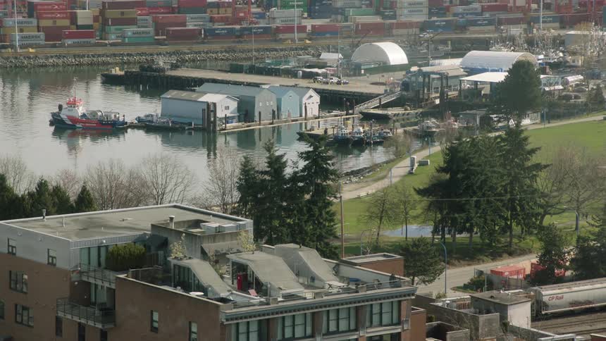 A loading dock with buildings trees and shipping containers