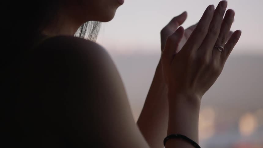 Woman claps her hands in the apartment during the lockdown