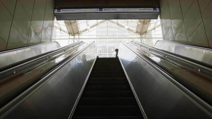 An escalator with people walking up it