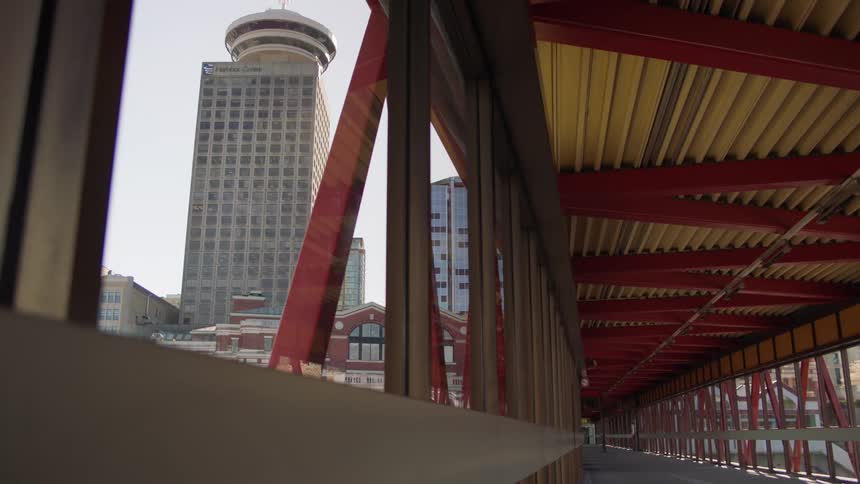 A corridor with buildings in the background