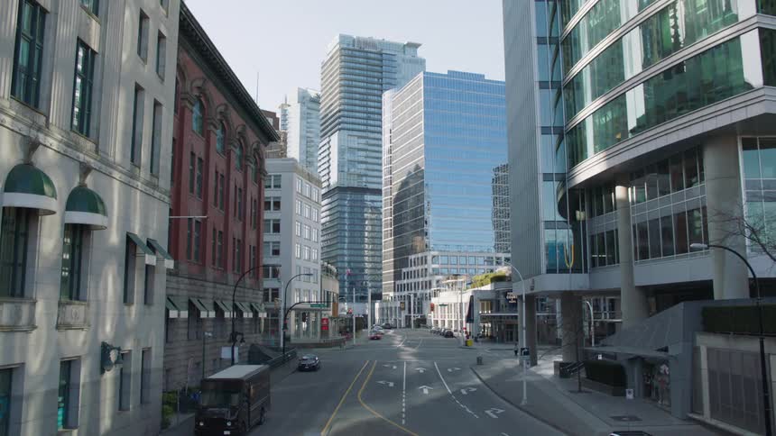 A vehicle drives through a mostly abandoned downtown urban area