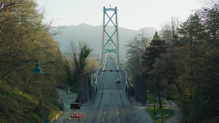 A car crosses the empty bridge in the late afternoon