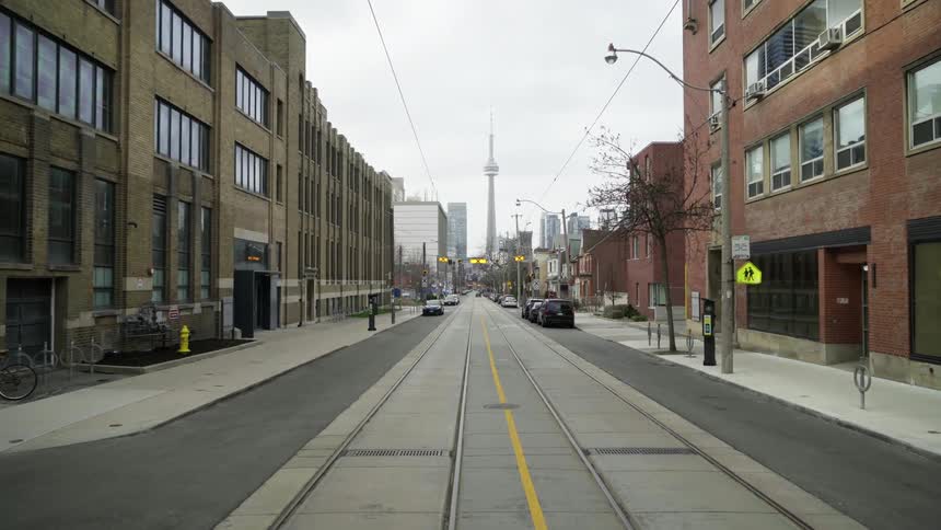 A street through a neighborhood stretches off to a downtown area