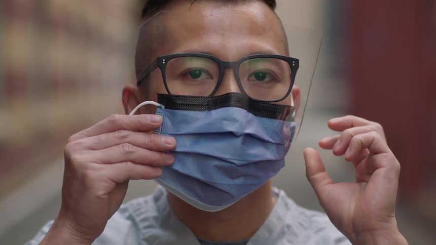 The man puts on a mask