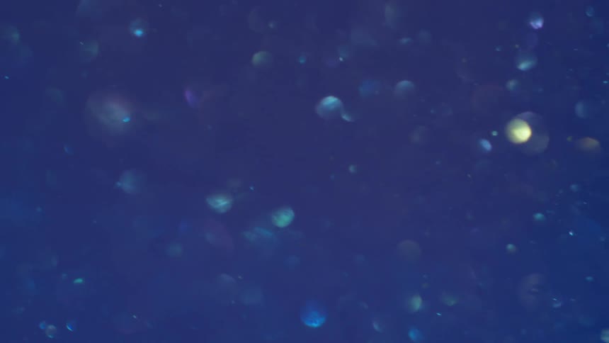 Flowing particles in blue liquid