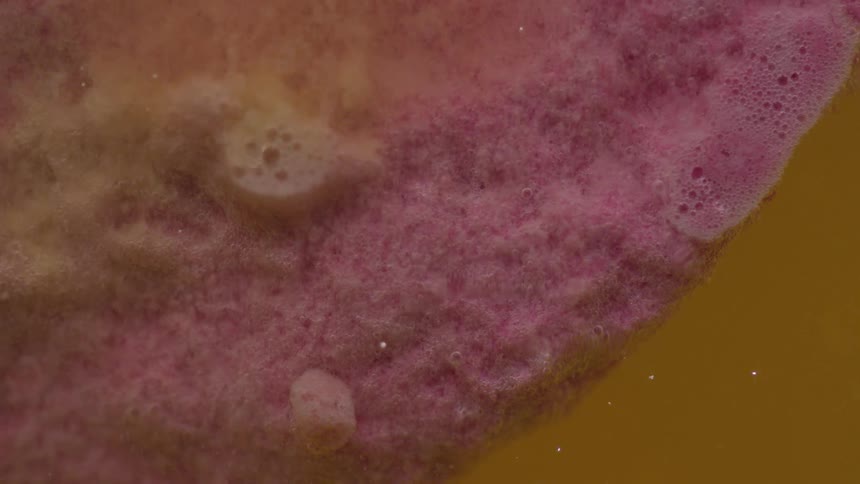 Yellow pink and white colors that look like liquid and bubbles