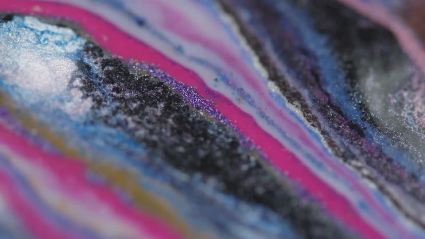 Flowing colorful liquid with glitter