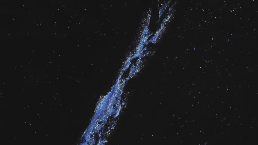 Flowing blue liquid with glitter