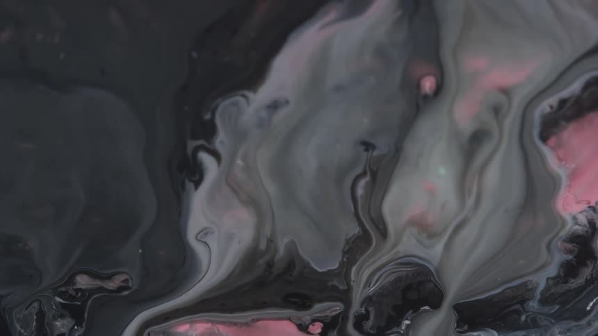 Flowing white black and pink liquid