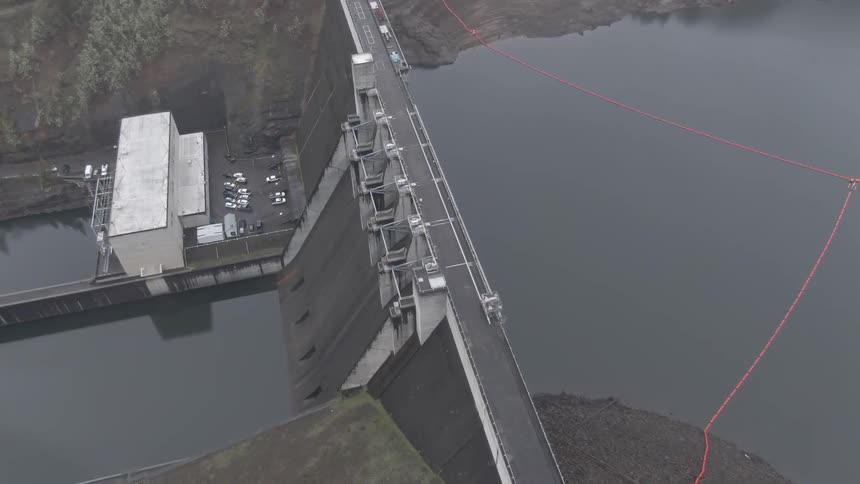 Aerial view of a gravity dam retaining water in a reservoir
