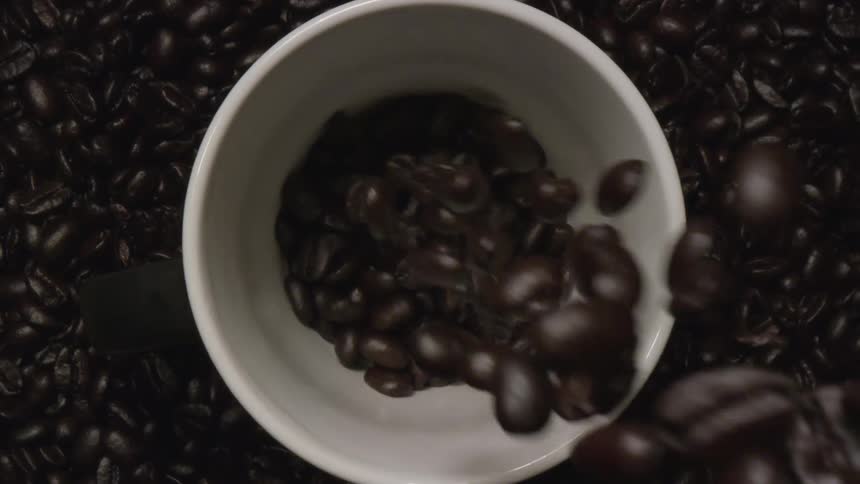 Coffee beans falling in to a bowl in a studio