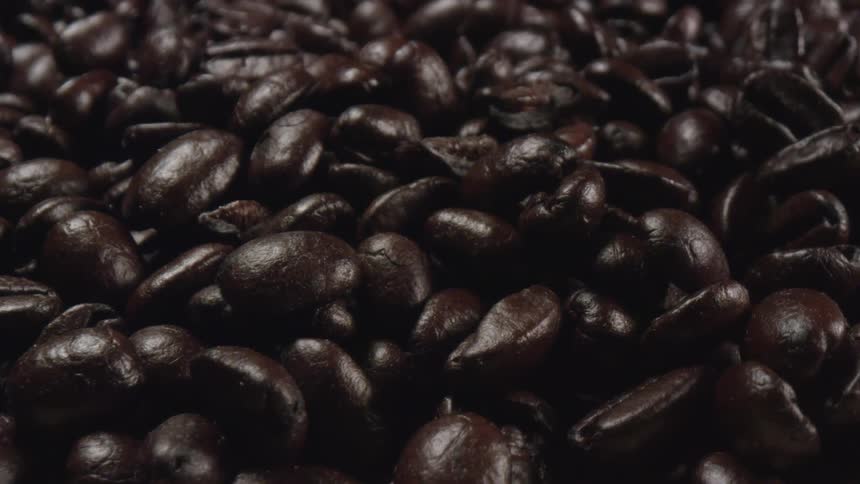 A closeup view of coffee beans are on a table