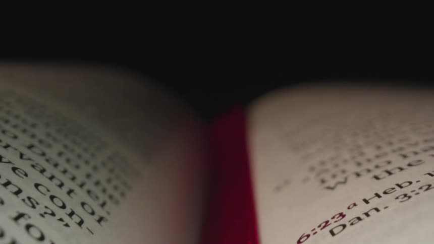 Bible pages with gilt edges and red ribbon bookmark