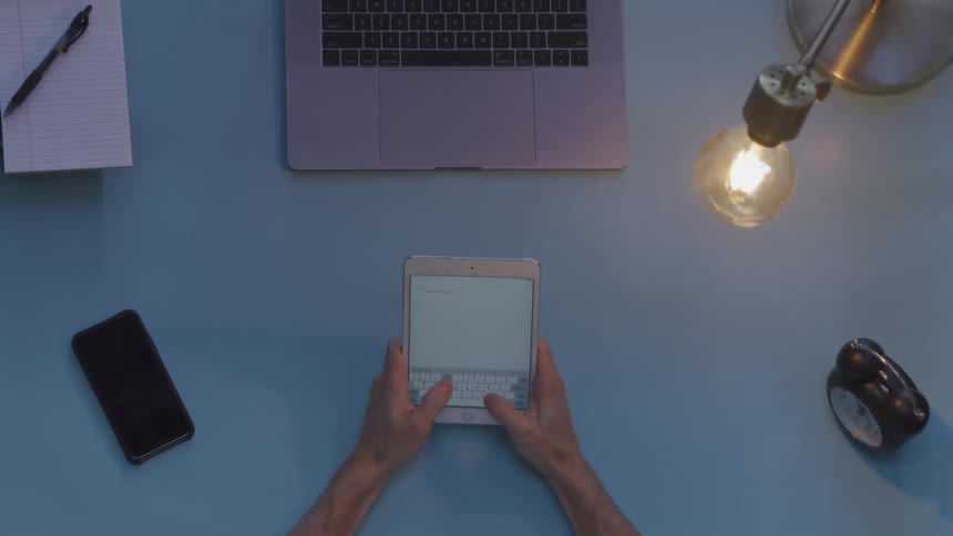 A person is typing on their tablet