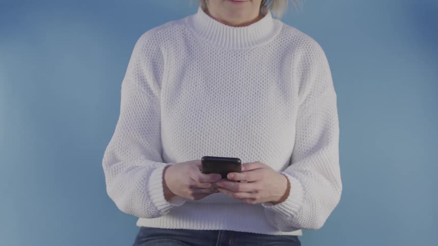 A woman is using a cell phone and talking on it
