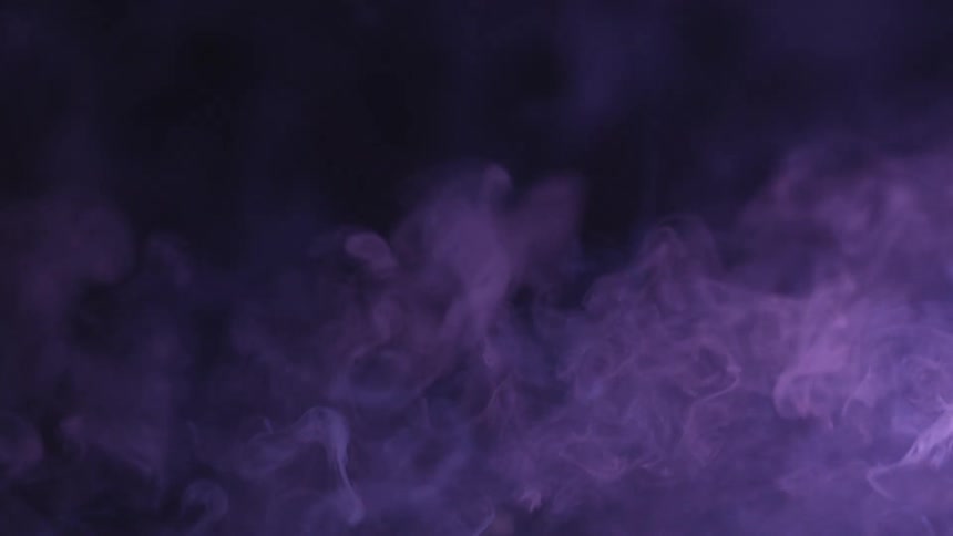 Smoke floating away from a fire in the dark