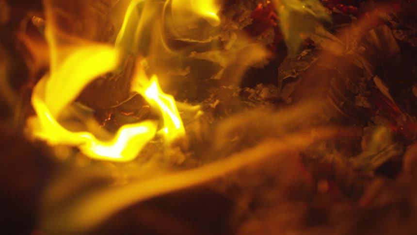 A fire burning with ashes and smoke