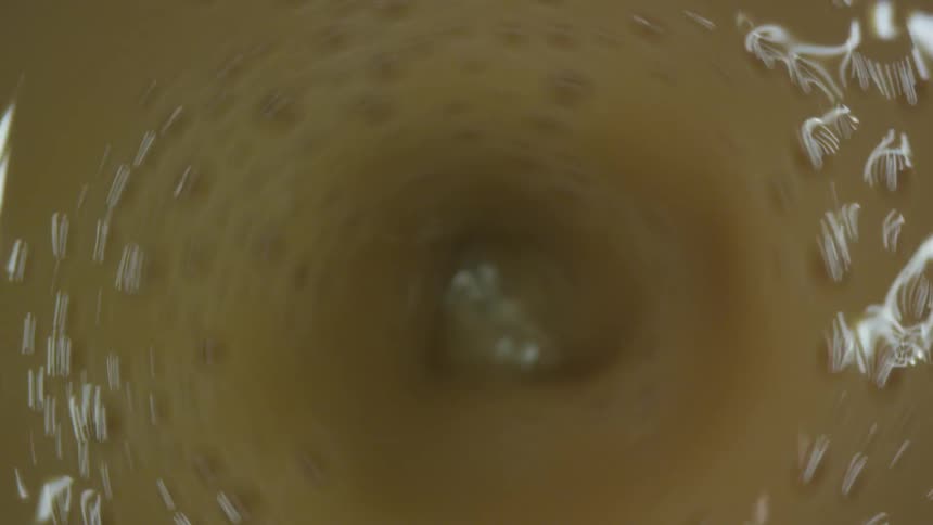 Birds eye view of bubbles in a drink after being stirred